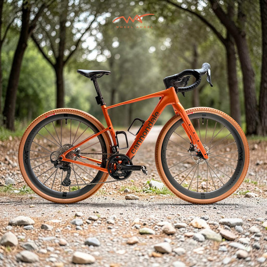 Orange Cannondale Topstone gravel bike upgraded with Wheel Angel GX i29 carbon wheels and Vittoria Terreno Pro T50 tan wall tires