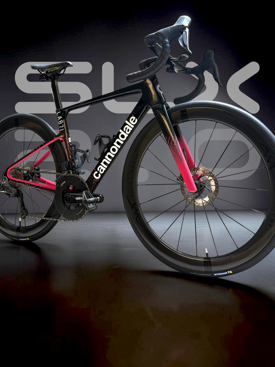 Side profile of a black and pink Cannondale road bike equipped with Wheel Angel SLX 2.0 deep-section carbon wheels.
