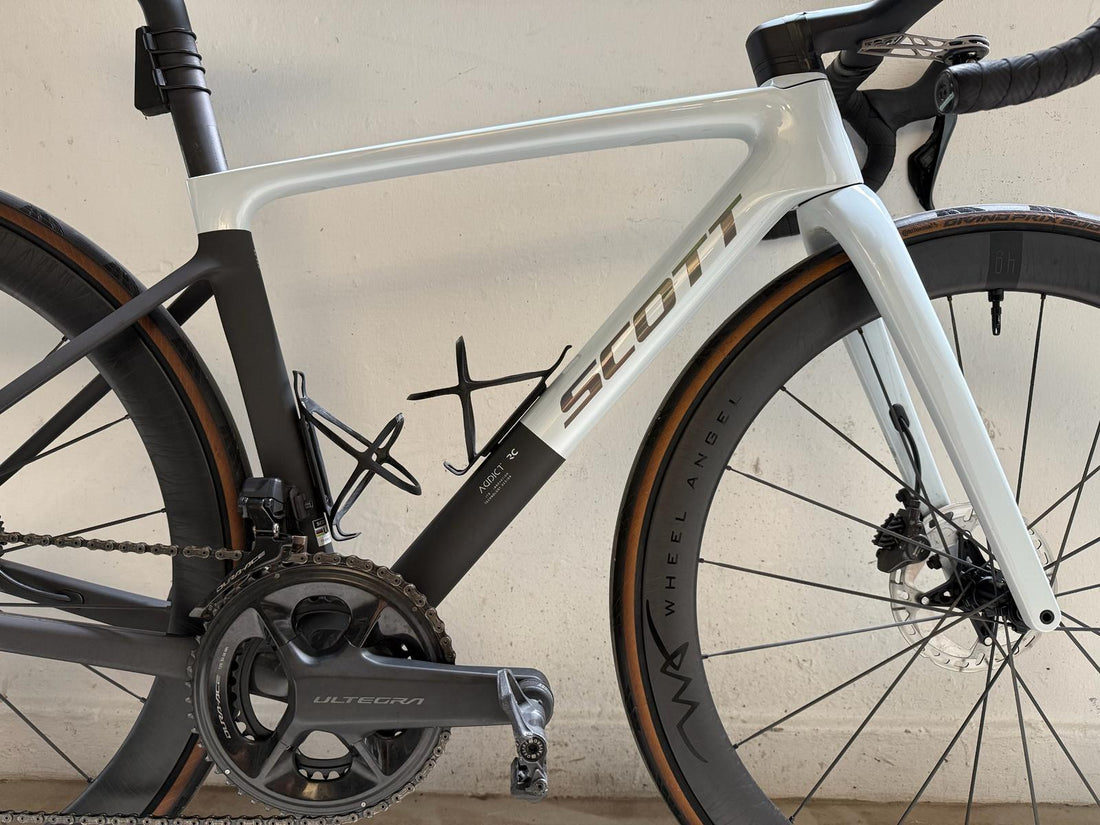 Side profile detail of Wheel Angel hand built carbon spoke wheels on a Scott Addict RC frame