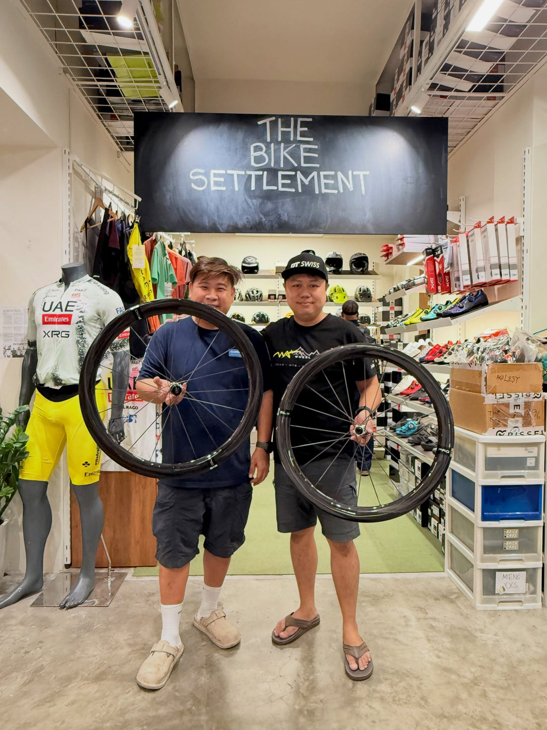 Kelvin from The Bike Settlement showcasing the Wheel Angel SLX PRO 52 carbon spoke wheelset in-store