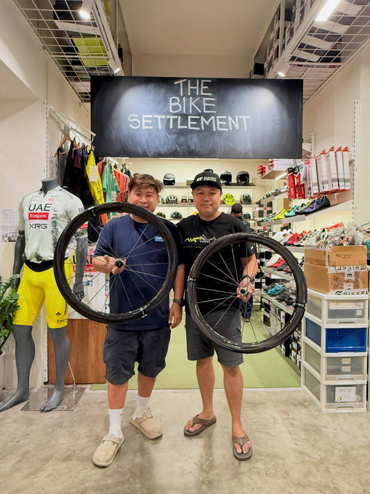 Kelvin from The Bike Settlement showcasing the Wheel Angel SLX PRO 52 carbon spoke wheelset in-store